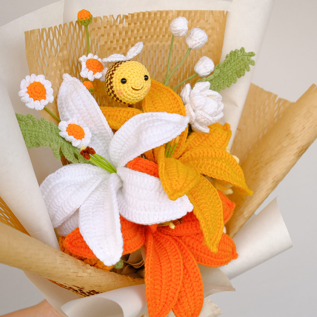 handmade crochet bee with white and orange lily bouquet