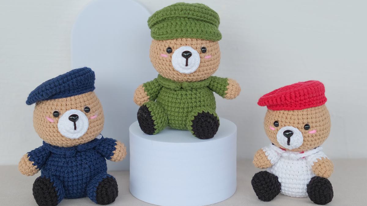 Three crocheted teddy bears in different army outfits